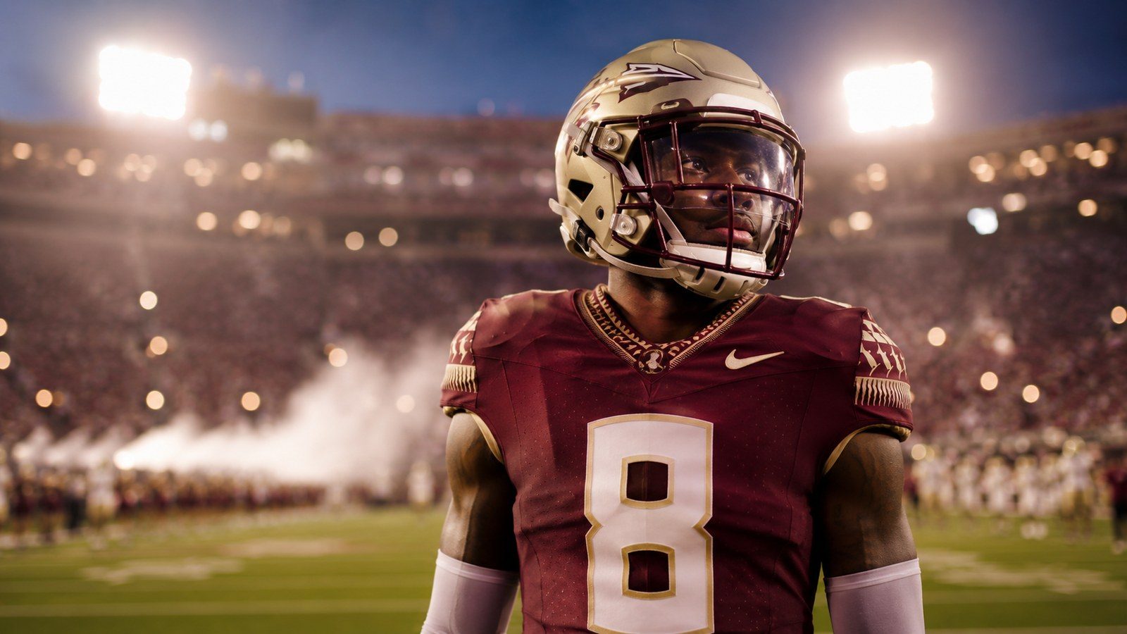 A young receiver on the field before kickoff under the lights