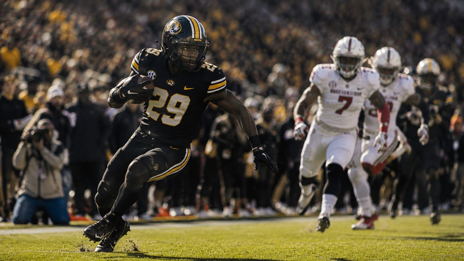 A running back cutting into open space with defenders in pursuit