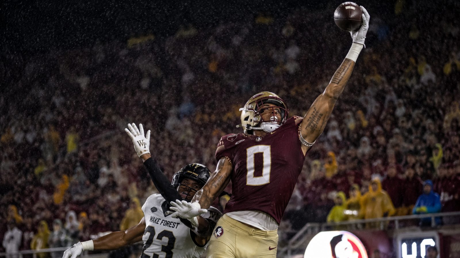 A receiver at full extension for a one-handed catch in the rain